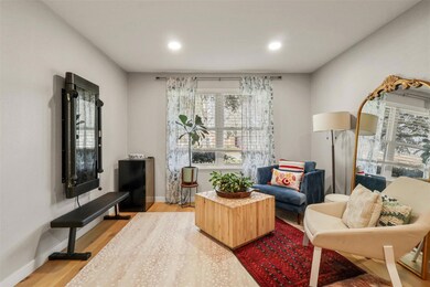 Living room with recessed lighting, light wood-sty