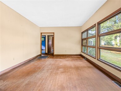 Spacious living room with high ceiling and a wall
