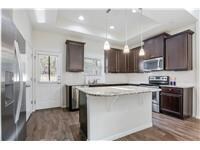 Kitchen with dark brown cabinets, light counterto