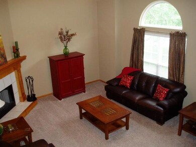 Living Room with Vaulted Ceiling and Fireplace