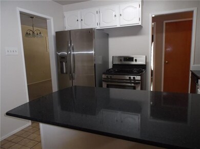 Kitchen off of dining room, hall and den