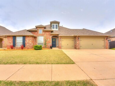 View of front of house with a garage and a front y