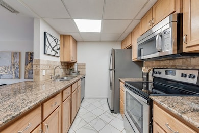 Kitchen featuring appliances with stainless steel finishes and granite counters
