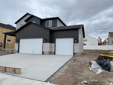 View of front of house featuring board and batten siding, concrete driveway, and an attached garage