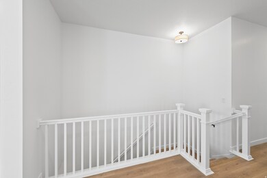 Stairway featuring wood finished floors and baseboards