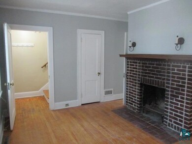 Unfurnished living room featuring ornamental moldi