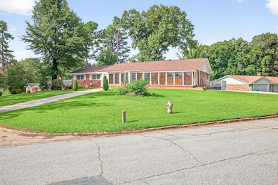 Ranch-style house with brick siding and a front lawn