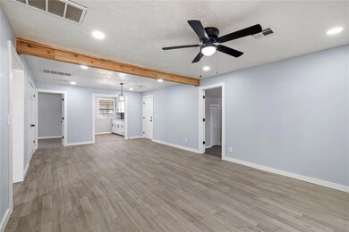 Unfurnished living room with beamed ceiling, light