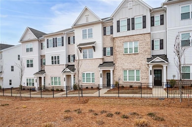 Townhome / multi-family property with board and batten siding and brick siding