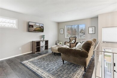 UPPER LIVING ROOM W/ NATURAL LIGHT POURING IN FROM