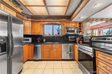 Stainless steel appliances and black granite