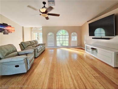 Living room with french doors, light wood-type flo