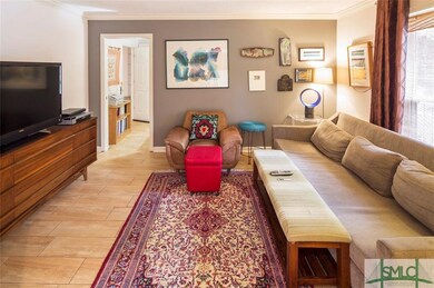 Living room with door to office and one of two ent