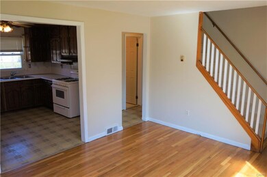 Opening into the kitchen and the bedroom hallway, 