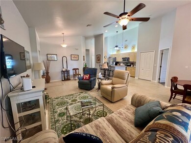 Tiled living room with a towering ceiling and ceil