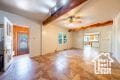 Unfurnished living room with beam ceiling