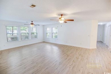 Unfurnished room with light wood-style flooring and ceiling fan