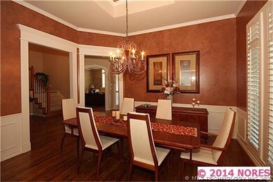 Formal dining with wainscoting & hardwood flooring