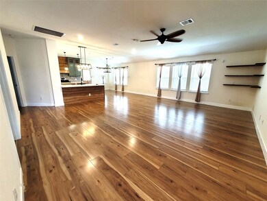 As you enter the home you walk into the huge bright family room which features solid surface flooring and a ceiling fan in the center of the room