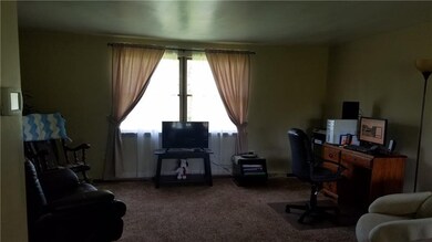 Living Room with newer carpet and open area to the
