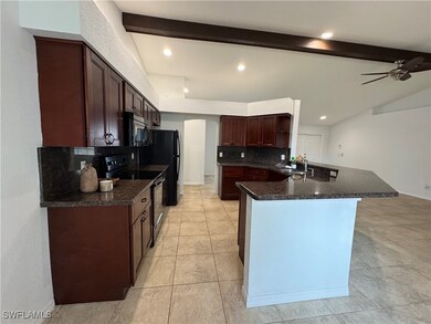 Kitchen featuring dark countertops, stainless stee