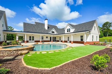 View of swimming pool with a yard, an in ground ho