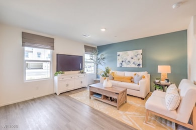 Living area featuring baseboards, recessed lightin