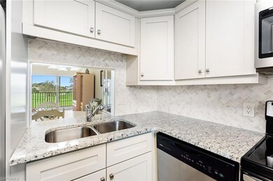 Kitchen with white cabinets, decorative backsplash