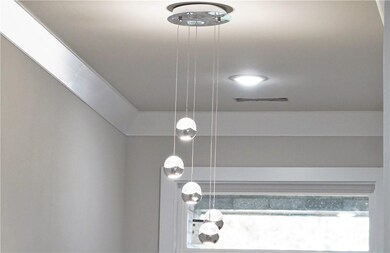 Fantastic crystal chandelier in foyer is so beautiful & a real eye catcher.