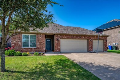 View of front of property featuring a garage and a front yard