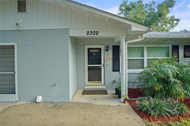 Covered front entry with glass storm door.