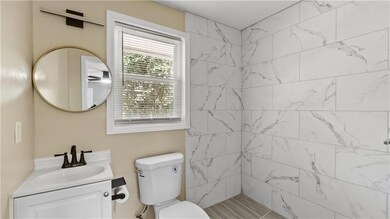 Bathroom with vanity and tiled shower