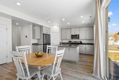Dining room featuring light wood-style flooring and recessed lighting