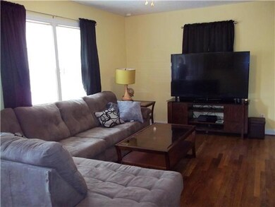Good sized living room with large window and wood 