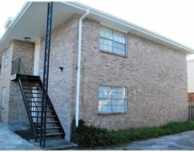 Exterior Back. Additional parking / storage area behind building.