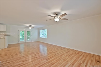 Open concept plan with Living Room open to Dining Room with plenty of natural light!