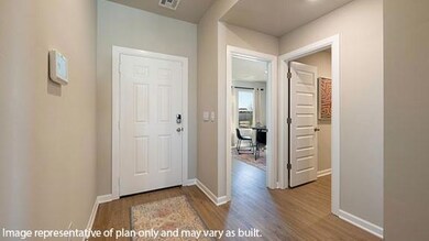 Foyer featuring baseboards and dark wood-type flooring