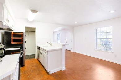 Kitchen featuring tile counters, finished concret