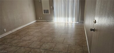 Spare room with visible vents, a textured wall, an