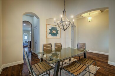 Dining Room With A Butler's Pantry Leading Into The Kitchen. Hardwood / Wood-Style Flooring, And High Ceilings.