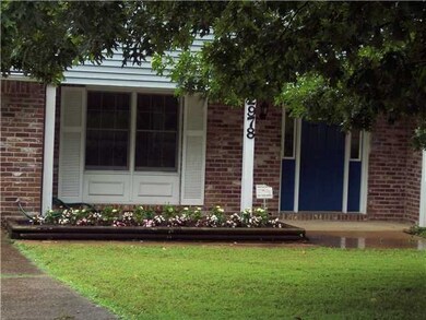 Freshly painted front door and spring flowers welc