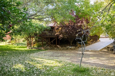 View of green lawn featuring a wooden deck