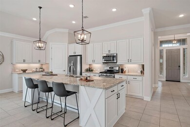 Kitchen featuring crown molding, a sink, applianc