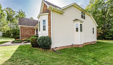 View of side of home with a lawn