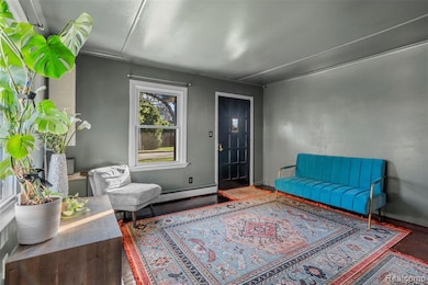 Living area with baseboard heating and baseboards