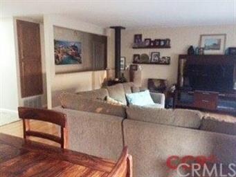 Living/Dining room with wood burning fireplace and