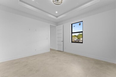 Unfurnished room with crown molding, a tray ceilin