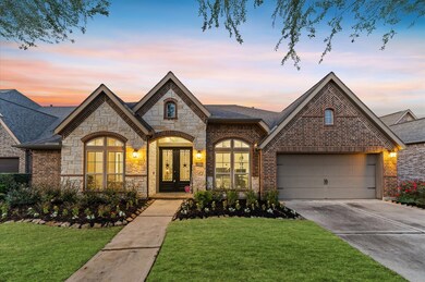 A beautifully landscaped front yard welcomes you h