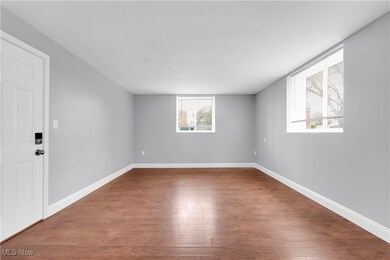 Empty room with wood finished floors and baseboards