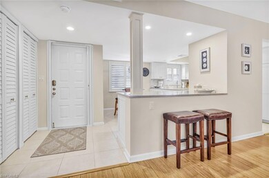 Kitchen featuring baseboards, white cabinetry, a peninsula, and a breakfast bar area
